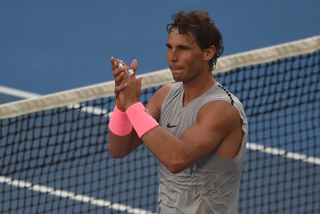 Spain's Rafael Nadal celebrates beating Argentina's Diego Schwartzman in their men's singles fourth round match on day seven of the Australian Open tennis tournament in Melbourne on January 21, 2018. / AFP PHOTO / PETER PARKS / -- IMAGE RESTRICTED TO EDITORIAL USE - STRICTLY NO COMMERCIAL USE --        (Photo credit should read PETER PARKS/AFP/Getty Images)