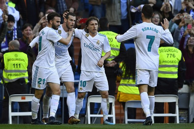Real Madrid's Welsh forward Gareth Bale (2L) celebrates with Real Madrid's Spanish forward Borja Mayoral (L), Real Madrid's Croatian midfielder Luka Modric (2R) and Real Madrid's Portuguese forward Cristiano Ronaldo after scoring during the Spanish league football match between Real Madrid CF and RC Deportivo de la Coruna at the Santiago Bernabeu stadium in Madrid on January 21, 2018. / AFP PHOTO / OSCAR DEL POZO        (Photo credit should read OSCAR DEL POZO/AFP/Getty Images)