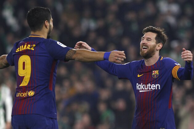 Barcelona's Messi, right, celebrates with teammate Suarez after scoring against Betis during the La Liga soccer match between Barcelona and Betis at the Villamarin stadium, in Seville, Spain on Sunday, Jan. 21, 2018. (AP Photo/Miguel Morenatti)