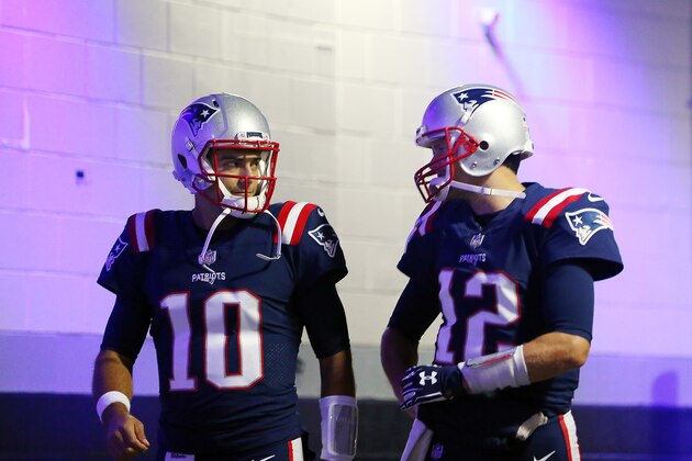 FOXBORO, MA - OCTOBER 22:  Tom Brady #12 and Jimmy Garoppolo #10 of the New England Patriots walk through the tunnel before a game against the Atlanta Falcons at Gillette Stadium on October 22, 2017 in Foxboro, Massachusetts.  (Photo by Adam Glanzman/Getty Images)
