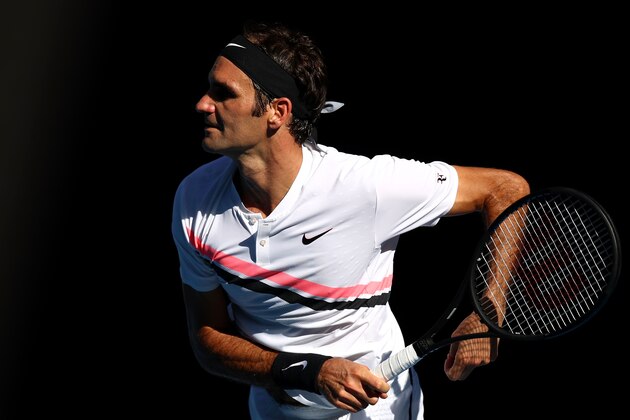 MELBOURNE, AUSTRALIA - JANUARY 22:  Roger Federer of Switzerland serves in his fourth round match against Marton Fucsovics of Hungary on day eight of the 2018 Australian Open at Melbourne Park on January 22, 2018 in Melbourne, Australia.  (Photo by Cameron Spencer/Getty Images)