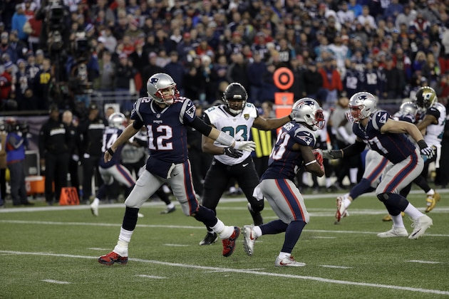New England Patriots quarterback Tom Brady (12) hands off the ball to running back Dion Lewis (33) during the second half of the AFC championship NFL football game against the Jacksonville Jaguars, Sunday, Jan. 21, 2018, in Foxborough, Mass. (AP Photo/David J. Phillip)