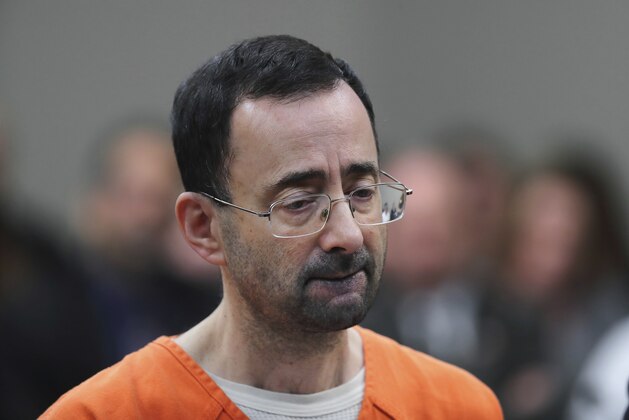 In this Nov. 22, 2017 file photo, Dr. Larry Nassar, 54, appears in court for a plea hearing in Lansing, Mich. Nasser, a sports doctor accused of molesting girls while working for USA Gymnastics and Michigan State University pleaded, guilty to multiple charges of sexual assault and will face at least 25 years in prison.(AP Photo/Paul Sancya)