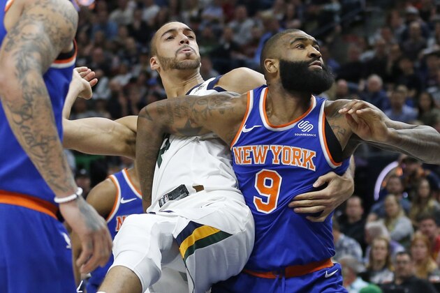 Utah Jazz center Rudy Gobert (27) and New York Knicks center Kyle O'Quinn (9) wait for a rebound during the second half of an NBA basketball game Friday, Jan. 19, 2018, in Salt Lake City. (AP Photo/Rick Bowmer)