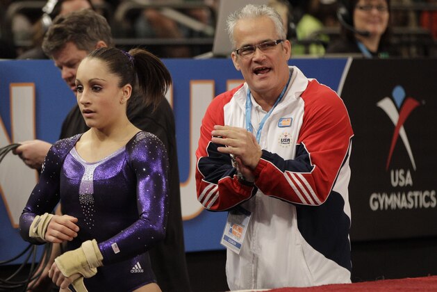 Women's All-Around champion Jordyn Wieber left is shown with her coach John Geddert during the American Cup gymnastics meet at Madison Square Garden in New York, Saturday, March 3, 2012.  (AP Photo/Kathy Willens)