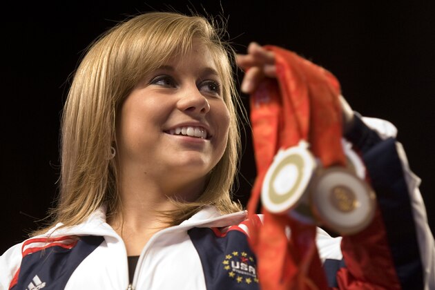 Olympic gymnast Shawn Johnson shows off her medals at her welcome home ceremony at Wells Fargo Arena in Des Moines, Iowa, on Tuesday, Aug. 26, 2008. Johnson won the gold medal in the balance beam. (AP Photo/Kevin Sanders)