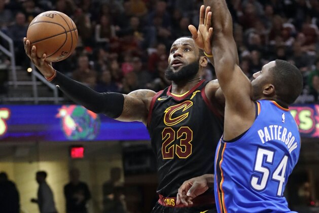 Cleveland Cavaliers' LeBron James (23) drives to the basket against Oklahoma City Thunder's Patrick Patterson (54) in the first half of an NBA basketball game, Saturday, Jan. 20, 2018, in Cleveland. (AP Photo/Tony Dejak)
