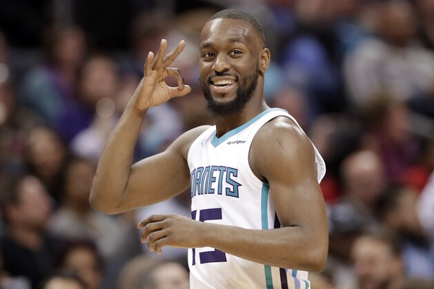 Charlotte Hornets' Kemba Walker (15) reacts to a teammate's basket against the Sacramento Kings during the second half of an NBA basketball game in Charlotte, N.C., Monday, Jan. 22, 2018. (AP Photo/Chuck Burton)