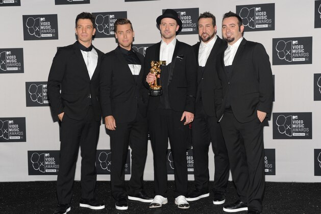 Justin Timberlake, center, winner of the video vanguard award poses backstage with, from left, JC Chasez, Lance Bass, Joey Fatone and Chris Kirkpatrick of 'N Sync  at the MTV Video Music Awards on Sunday, Aug. 25, 2013, at the Barclays Center in the Brooklyn borough of New York. (Photo by Evan Agostini/Invision/AP)
