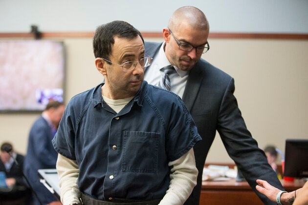 Former USA Gymnastics doctor Larry Nassar is about to be led away following his sentencing hearing in Lansing, Michigan, January 16, 2018.
Victims of sexual abuse by Nassar delivered gut-wrenching emotional testimony at the court hearing which could see him sentenced to prison for life. Nassar has been accused of molesting more than 100 female athletes during the three decades he worked with USA Gymnastics and at Michigan State University. / AFP PHOTO / Geoff Robins        (Photo credit should read GEOFF ROBINS/AFP/Getty Images)