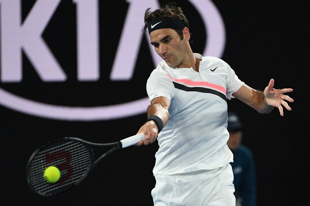 Switzerland's Roger Federer hits a return against Czech Republic's Tomas Berdych during their men's singles quarter-finals match on day 10 of the Australian Open tennis tournament in Melbourne on January 24, 2018. / AFP PHOTO / SAEED KHAN / -- IMAGE RESTRICTED TO EDITORIAL USE - STRICTLY NO COMMERCIAL USE --        (Photo credit should read SAEED KHAN/AFP/Getty Images)