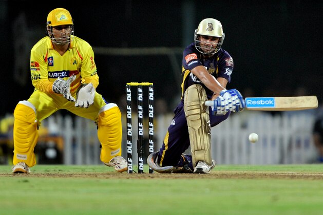 Kolkata Knight Riders batsman Manvinder Bisla plays a shot as Chennai Super Kings captain and wicket-keeper M.S. Dhoni (L) looks on during the IPL Twenty20 cricket final match between Chennai Super Kings (CSK) and Kolkata Knight Riders (KKR) at the M.A. Chidambaram Stadium in Chennai on May 27, 2012. KKR are chasing a target of 191runs set by CSK. RESTRICTED TO EDITORIAL USE. MOBILE USE WITHIN NEWS PACKAGE. AFP PHOTO/Manjunath KIRAN        (Photo credit should read Manjunath Kiran/AFP/GettyImages)