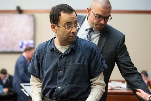 Former USA Gymnastics doctor Larry Nassar is about to be led away following his sentencing hearing in Lansing, Michigan, January 16, 2018.
Victims of sexual abuse by Nassar delivered gut-wrenching emotional testimony at the court hearing which could see him sentenced to prison for life. Nassar has been accused of molesting more than 100 female athletes during the three decades he worked with USA Gymnastics and at Michigan State University. / AFP PHOTO / Geoff Robins (Photo credit should read GEOFF ROBINS/AFP/Getty Images) Former USA Gymnastics doctor Larry Nassar is about to be led away following his sentencing hearing in Lansing, Michigan, January 16, 2018.
Victims of sexual abuse by Nassar delivered gut-wrenching emotional testimony at the court hearing which could see him sentenced to prison for life. Nassar has been accused of molesting more than 100 female athletes during the three decades he worked with USA Gymnastics and at Michigan State University. / AFP PHOTO / Geoff Robins (Photo credit should read GEOFF ROBINS/AFP/Getty Images)