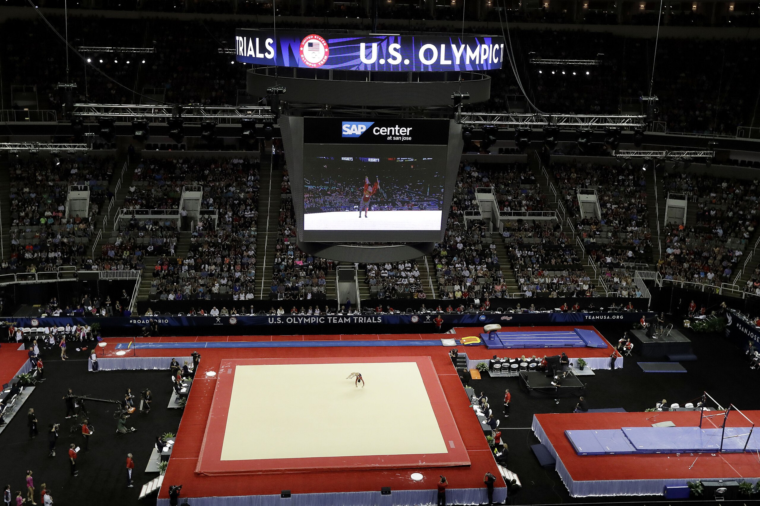 Aly Raisman, center, competes on the floor exercise during the women's U.S. Olympic gymnastics trials in San Jose, Calif., Friday, July 8, 2016. (AP Photo/Gregory Bull)