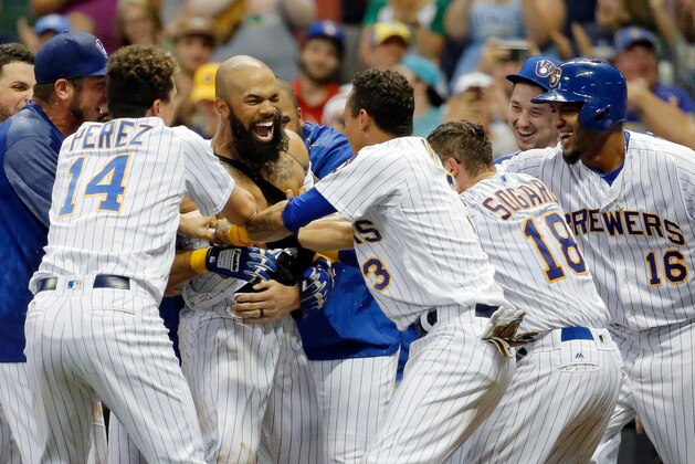 MILWAUKEE, WI - JUNE 16: Eric Thames #7 of the Milwaukee Brewers (C) is mobbed by teammates after hitting a walkoff home run against the San Diego Padres during the tenth inning at Miller Park on June 16, 2017 in Milwaukee, Wisconsin. The Milwaukee Brewers won 6-5 in ten innings.  (Photo by Jon Durr/Getty Images)