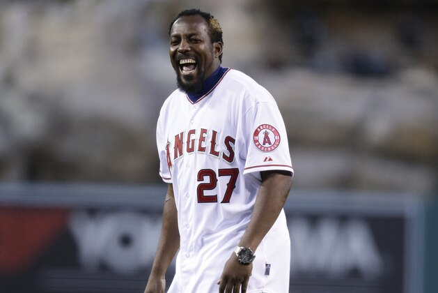 FILE - In this March 31, 2014, file photo, Vladimir Guerrero laughs after throwing the ceremonial first pitch before an opening day baseball game between the Los Angeles Angels and the Seattle Mariners, in Anaheim, Calif. Guerrero is expected to be inducted into the baseball hall of fame in 2017. (AP Photo/Jae C. Hong, File)