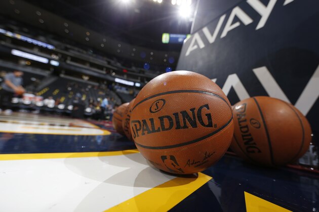 Splading warm-up basketballs sit on court during the first half of an NBA basketball game Sunday, Jan. 17, 2016, in Denver. (AP Photo/David Zalubowski)