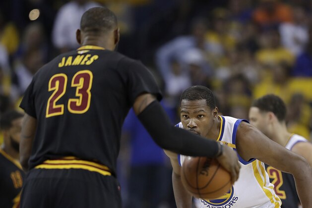 Golden State Warriors forward Kevin Durant, right, defends Cleveland Cavaliers forward LeBron James (23) during the first half of Game 5 of basketball's NBA Finals in Oakland, Calif., Monday, June 12, 2017. (AP Photo/Marcio Jose Sanchez)