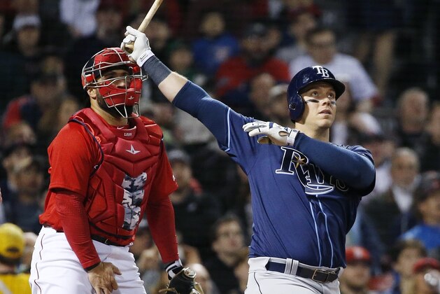 Tampa Bay Rays' Logan Morrison, right, watches his grand slam in front of Boston Red Sox's Sandy Leon during the third inning of a baseball game in Boston, Friday, April 14, 2017. (AP Photo/Michael Dwyer)
