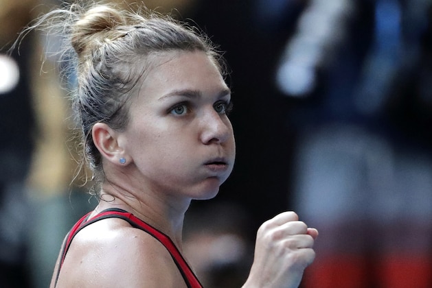 Romania's Simona Halep celebrates after defeating Germany's Angelique Kerber in their semifinal at the Australian Open tennis championships in Melbourne, Australia, Thursday, Jan. 25, 2018. (AP Photo/Vincent Thian)