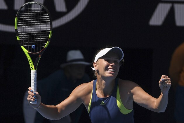 Denmark's Caroline Wozniacki celebrates after defeating Belgium's Elise Mertens after winning their semifinal at the Australian Open tennis championships in Melbourne, Australia, Thursday, Jan. 25, 2018. (AP Photo/Andy Brownbill)