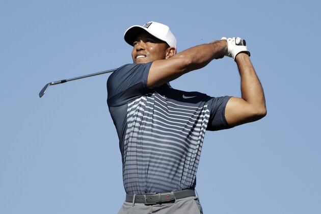 Tiger Woods watches his tee shot on the 15th hole on the North Course at Torrey Pines Golf Course during the second round of Farmers Insurance Open golf tournament Friday, Jan. 26, 2018, in San Diego. (AP Photo/Gregory Bull)