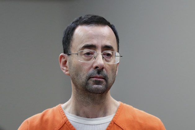 In this Nov. 22, 2017 file photo, Dr. Larry Nassar, 54, appears in court for a plea hearing in Lansing, Mich. Nasser, a sports doctor accused of molesting girls while working for USA Gymnastics and Michigan State University pleaded, guilty to multiple charges of sexual assault and will face at least 25 years in prison.(AP Photo/Paul Sancya)