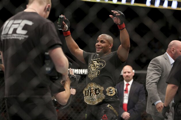 Daniel Cormier wears the belt after a win over Volkan Oezdemir in a light heavyweight championship mixed martial arts bout at UFC 220, Saturday, Jan. 20, 2018, in Boston.  (AP Photo/Gregory Payan)