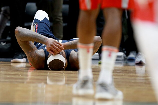 NEW ORLEANS, LA - JANUARY 26:  DeMarcus Cousins #0 of the New Orleans Pelicans lies down on the ground after injuring his ankle during the second half of a NBA game against the Houston Rockets at the Smoothie King Center on January 26, 2018 in New Orleans, Louisiana. NOTE TO USER: User expressly acknowledges and agrees that, by downloading and or using this photograph, User is consenting to the terms and conditions of the Getty Images License Agreement.  (Photo by Sean Gardner/Getty Images)
