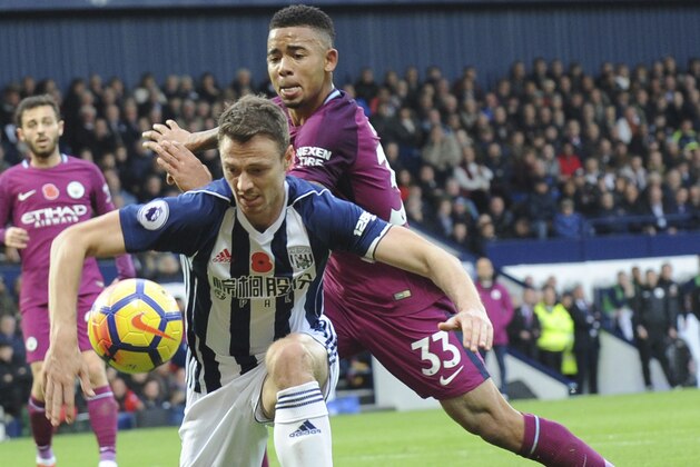 Manchester City's Gabriel Jesus, right, and West Brom's Jonny Evans battle for the ball during the English Premier League soccer match between West Bromwich Albion and Manchester City, at the Hawthorns in West Bromwich, England, Saturday, Oct. 28, 2017. (AP Photo/Rui Vieira)