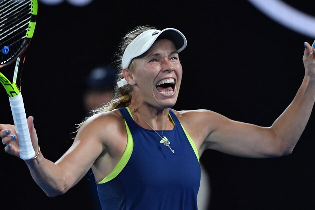 Denmark's Caroline Wozniacki celebrates beating Romania's Simona Halep in their women's singles final match on day 13 of the Australian Open tennis tournament in Melbourne on January 27, 2018. / AFP PHOTO / Greg Wood / -- IMAGE RESTRICTED TO EDITORIAL USE - STRICTLY NO COMMERCIAL USE --        (Photo credit should read GREG WOOD/AFP/Getty Images)
