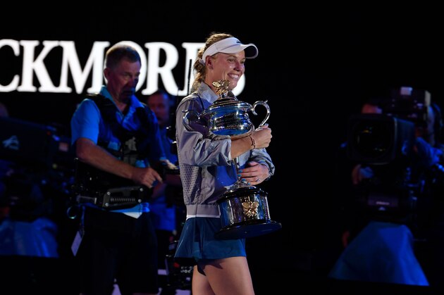 Denmark's Caroline Wozniacki celebrates with the championship trophy during the awards ceremony after her victory against Romania's Simona Halep in the women's singles final on day 13 of the Australian Open tennis tournament in Melbourne on January 27, 2018. / AFP PHOTO / SAEED KHAN / -- IMAGE RESTRICTED TO EDITORIAL USE - STRICTLY NO COMMERCIAL USE --        (Photo credit should read SAEED KHAN/AFP/Getty Images)