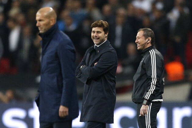 Tottenham Hotspur's Argentinian head coach Mauricio Pochettino (C) laughs by Real Madrid's French coach Zinedine Zidane (L) during the UEFA Champions League Group H football match between Tottenham Hotspur and Real Madrid at Wembley Stadium in London, on November 1, 2017. / AFP PHOTO / IKIMAGES / Ian KINGTON        (Photo credit should read IAN KINGTON/AFP/Getty Images)
