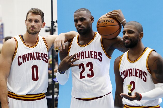 Cleveland Cavaliers forward Kevin Love (0), LeBron James (23) and Kyrie Irving (2) pose for photographs during the NBA basketball team's media day, Monday, Sept. 26, 2016, in Independence, Ohio. (AP Photo/Ron Schwane)