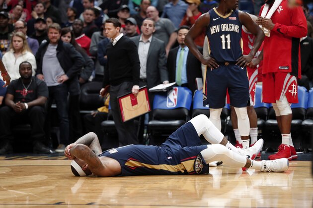 New Orleans Pelicans center DeMarcus Cousins lies on the court after injuring his left achilles tendon, according to the team, in the second half of an NBA basketball game against the Houston Rockets in New Orleans, Friday, Jan. 26, 2018. The Pelicans won 115-113. (AP Photo/Gerald Herbert)