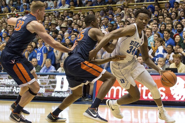 Duke's Wendall Carter, Jr. (34) drives against the defense of Virginia's Mamadi Diakite (25) and Jack Salt (33) during the first half of an NCAA college basketball game in Durham, N.C., Saturday, Jan. 27, 2018. (AP Photo/Ben McKeown)