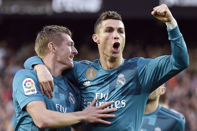 Real Madrid's German midfielder Toni Kroos (L) celebrates a goal with Real Madrid's Portuguese forward Cristiano Ronaldo during the Spanish league football match between Valencia CF and Real Madrid CF at the Mestalla stadium in Valencia on January 27, 2018. / AFP PHOTO / JOSE JORDAN        (Photo credit should read JOSE JORDAN/AFP/Getty Images)