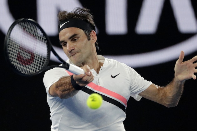 Switzerland's Roger Federer makes a forehand return to South Korea's Hyeon Chung during their semifinal at the Australian Open tennis championships in Melbourne, Australia, Friday, Jan. 26, 2018. (AP Photo/Dita Alangkara)