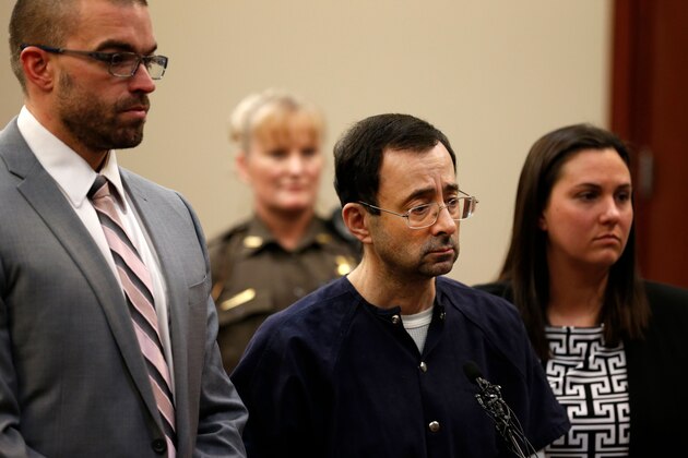 Former Michigan State University and USA Gymnastics doctor Larry Nassar (C) with defense attorneys  Matt Newberg (L) and Molly Blythe (R) during the sentencing phase in Ingham County Circuit Court on January 24, 2018 in Lansing, Michigan.
Disgraced former USA Gymnastics doctor Larry Nassar was sentenced to 40 to 175 years in prison on Wednesday for sexually abusing scores of young girls under the guise of medical treatment. 'I've just signed your death warrant,' Judge Rosemarie Aquilina said as she handed down the sentence after a week of gut-wrenching testimony by over 150 of Nassar's victims.
 / AFP PHOTO / JEFF KOWALSKY        (Photo credit should read JEFF KOWALSKY/AFP/Getty Images)