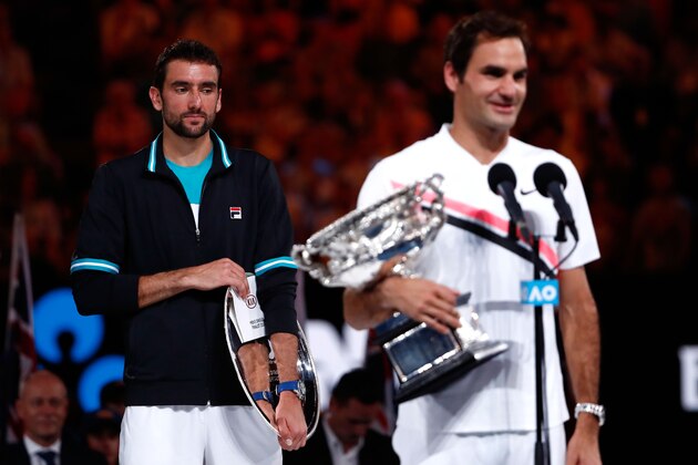 MELBOURNE, AUSTRALIA - JANUARY 28:  Marin Cilic (L) of Croatia poses with the runners-up trophy and Roger Federer of Switzerland poses with the Norman Brookes Challenge Cup after winning the 2018 Australian Open Men's Singles Final against on day 14 of the 2018 Australian Open at Melbourne Park on January 28, 2018 in Melbourne, Australia.  (Photo by Michael Dodge/Getty Images)