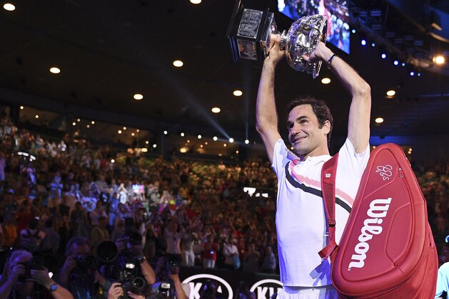 Switzerland's Roger Federer holds his trophy up after defeating Croatia's Marin Cilic in the men's singles final at the Australian Open tennis championships in Melbourne, Australia, Sunday, Jan. 28, 2018. (AP Photo/Andy Brownbill)