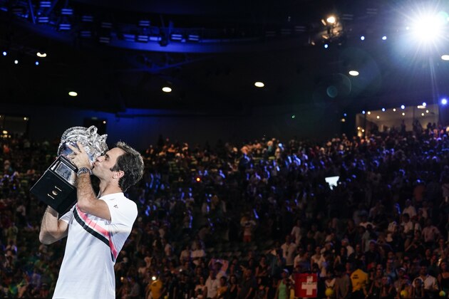 MELBOURNE, AUSTRALIA - JANUARY 28:  Roger Federer of Switzerland kisses the Norman Brookes Challenge Cup after winning the 2018 Australian Open Men's Singles Final against Marin Cilic of Croatia on day 14 of the 2018 Australian Open at Melbourne Park on January 28, 2018 in Melbourne, Australia.  (Photo by XIN LI/Getty Images)
