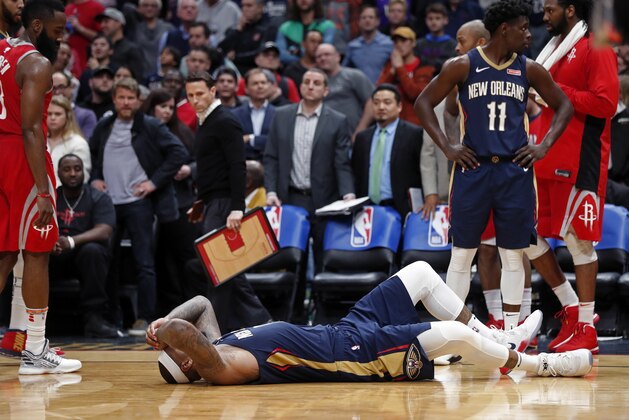 New Orleans Pelicans center DeMarcus Cousins lies on the court after injuring his left achilles tendon, according to the team, in the second half of an NBA basketball game against the Houston Rockets in New Orleans, Friday, Jan. 26, 2018. The Pelicans won 115-113. (AP Photo/Gerald Herbert)