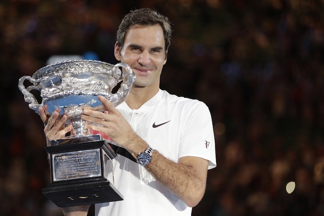 Switzerland's Roger Federer holds his trophy after defeating Croatia's Marin Cilic in the men's singles final at the Australian Open tennis championships in Melbourne, Australia, Sunday, Jan. 28, 2018. (AP Photo/Dita Alangkara)