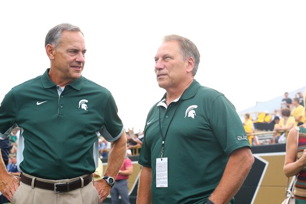 KALAMAZOO, MI - SEPTEMBER 4:  Head coach Mark Dantonio (L) of the Michigan State Spartans and Michigan State basketball coach Tom Izzo (R) watches from the sideline prior to the game against the Western Michigan Broncos at Waldo Stadium on September 4, 2015 in Kalamazoo, Michigan. (Photo by Rey Del Rio/Getty Images)