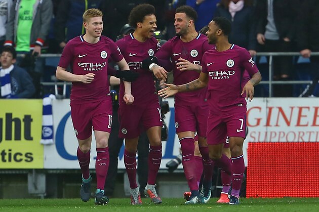 Manchester City's Belgian midfielder Kevin De Bruyne (L) celebrates with teammates after scoring the opening goal of the English FA Cup fourth round football match between Cardiff City and Manchester City at Cardiff City Stadium in Cardiff, south Wales on January 28, 2018. / AFP PHOTO / Geoff CADDICK / RESTRICTED TO EDITORIAL USE. No use with unauthorized audio, video, data, fixture lists, club/league logos or 'live' services. Online in-match use limited to 75 images, no video emulation. No use in betting, games or single club/league/player publications.  /         (Photo credit should read GEOFF CADDICK/AFP/Getty Images)