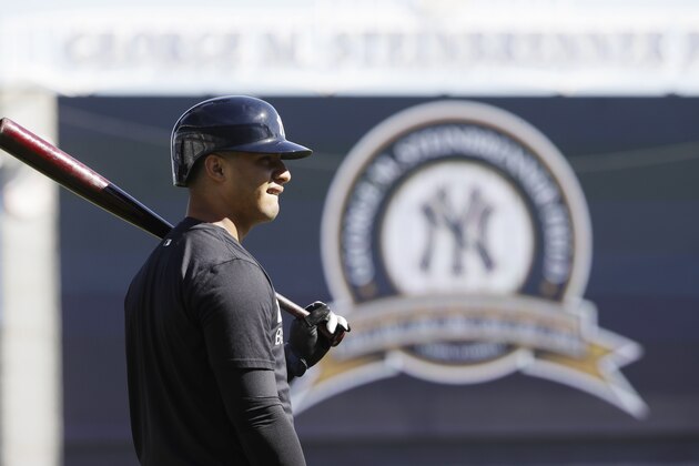 FILE - In this Feb. 17, 2017, file photo, New York Yankees' Gleyber Torres looks on during a spring training baseball workout, in Tampa, Fla. On the day top Yankees prospect Gleyber Torres turned 21, New York general manager Brian Cashman revealed the team's big league staff wanted him on last year's opening-day roster. Torres’ season ended when he tore a left elbow ligament in June, and he could start at third base or second base next year.  (AP Photo/Matt Rourke, File)