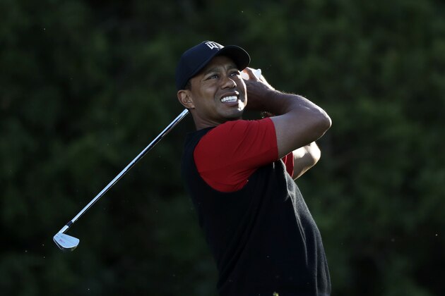 Tiger Woods watches his tee shot on the 11th hole of the South Course at Torrey Pines Golf Course during the final round of the Farmers Insurance Open golf tournament, Sunday, Jan. 28, 2018, in San Diego. (AP Photo/Gregory Bull)