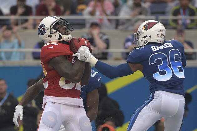AFC tight end Delanie Walker (82), of the Tennessee Titans grabs a touchdown pass over NFC safety Budda Baker (36), of the Arizona Cardinals, during the second half of the NFL Pro Bowl football game, Sunday, Jan. 28, 2018, in Orlando, Fla. (AP Photo/Phelan M Ebenhack)