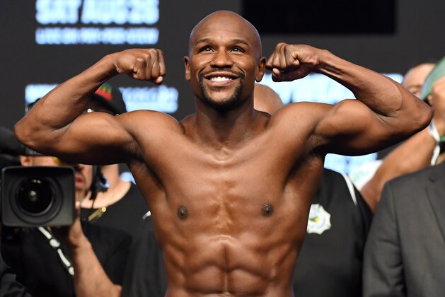 LAS VEGAS, NV - AUGUST 25:  Boxer Floyd Mayweather Jr. poses on the scale during his official weigh-in at T-Mobile Arena on August 25, 2017 in Las Vegas, Nevada. Mayweather will meet UFC lightweight champion Conor McGregor in a super welterweight boxing match at T-Mobile Arena on August 26.  (Photo by Ethan Miller/Getty Images)